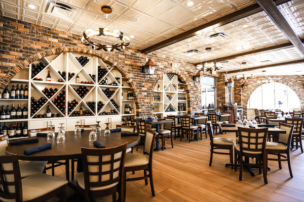 interior restaurant with wood floors and circular wine build-ins
